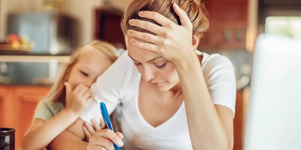 Mutter mit Kind bei der Arbeit am Schreibtisch
