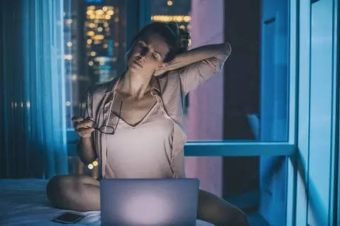 Frau arbeitet nachts am Laptop